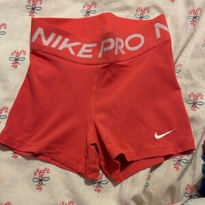 Nike Pro Coral-Red Women's Bike Shorts with White Swoosh
